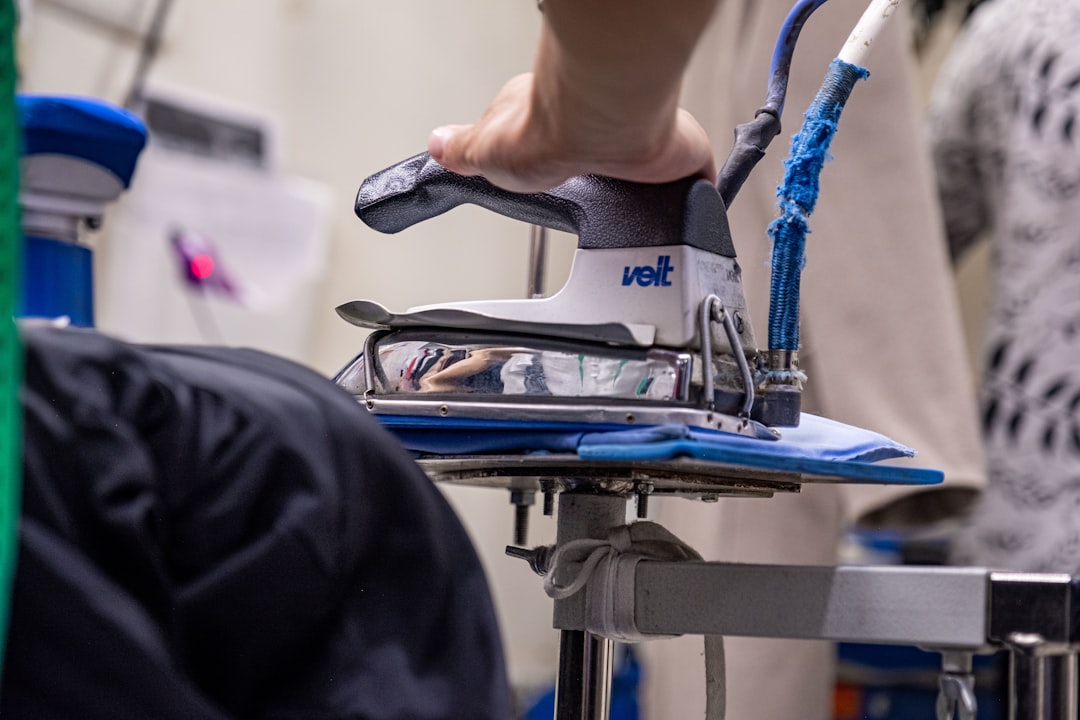 a-close-up-of-a-person-ironing-a-shirt-gemrf7xa7hs
