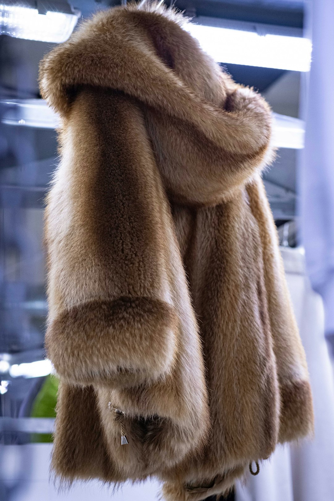 a-fur-coat-hanging-on-a-rack-in-a-store-unvxujytjdm